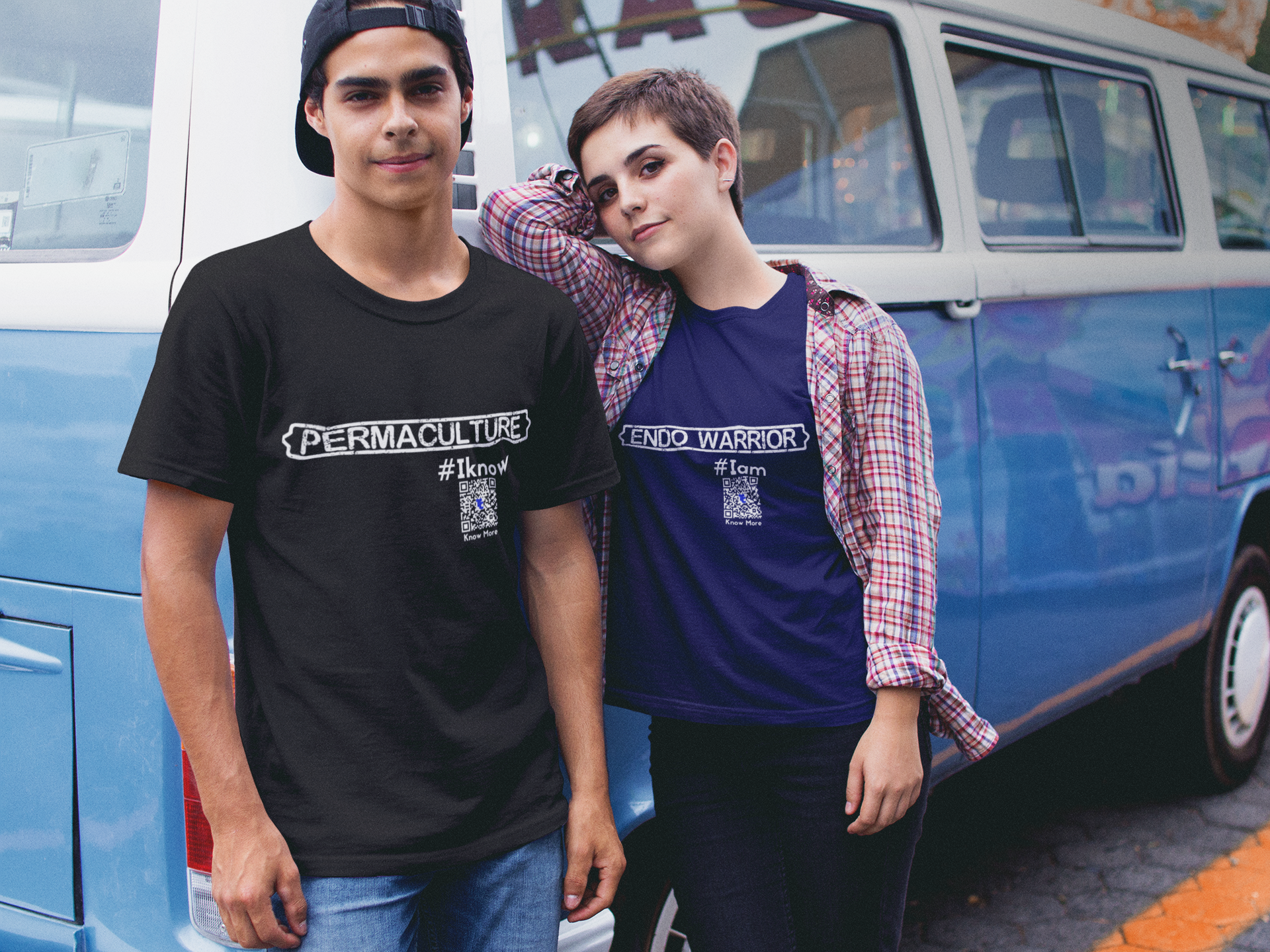 Title: Share The Story Behind Your CLAIM™. A male & female presenting couple are standing in front of a blue van. One person is wearing a black CLAIM It Tee™ with {PERMACULTURE} #Iknow. The other is wearing a navy blue one CLAIMING™ {ENDO WARRIOR} #Iam.